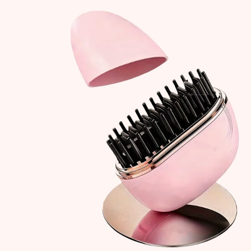 A pink egg-shaped hair brush with black bristles, shown with its matching pink lid floating above and a reflective base below on a pale pink background.